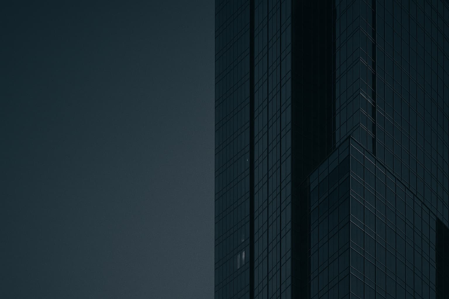 Abstract detail of a glass and steel skyscraper facade in Dubai at dusk, clean reflective geometric lines